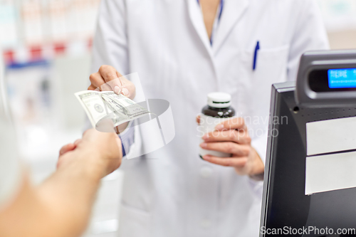 Image of close up of pharmacist selling drug at pharmacy