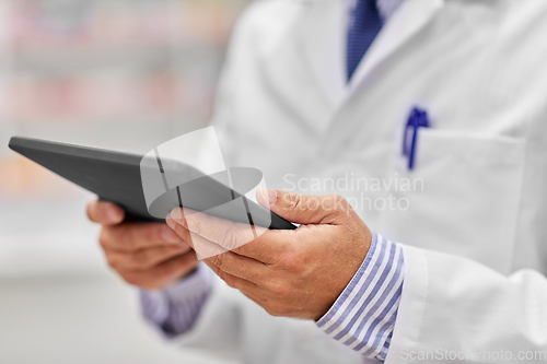 Image of close up of senior pharmacist with tablet pc