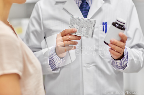 Image of male apothecary and woman with drug at pharmacy