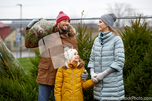 Image of happy family buying christmas tree at market