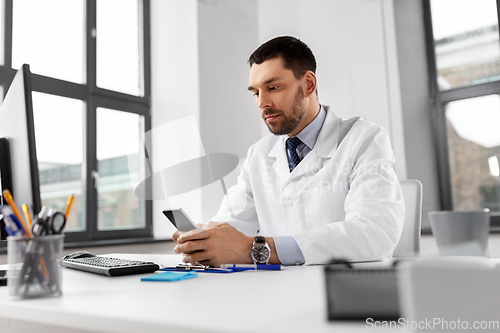 Image of male doctor with smartphone at hospital
