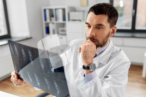 Image of male doctor with x-ray of spine at hospital