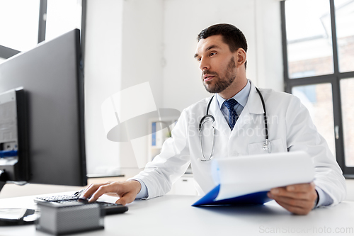 Image of male doctor with computer working at hospital