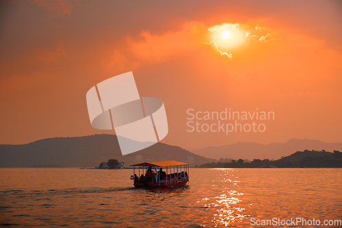 Image of Boat in lake Pichola on sunset. Udaipur, Rajasthan, India