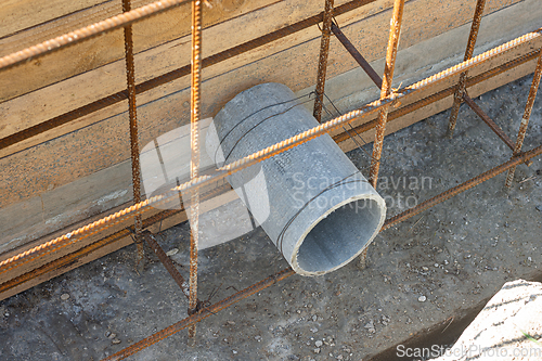 Image of Laying a sleeve for communications during the construction of a strip foundation