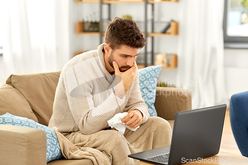 Image of sick man having video call on laptop at home