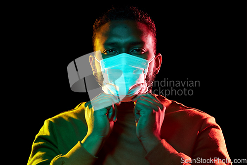 Image of african american man wearing medical mask