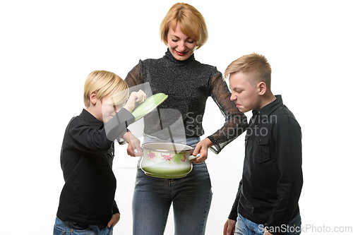 Image of Mom cooked the soup, the children opened the pot and they did not like the food, isolated on a white background