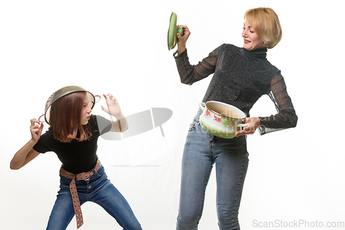 Image of Mom and daughter have fun using kitchen utensils