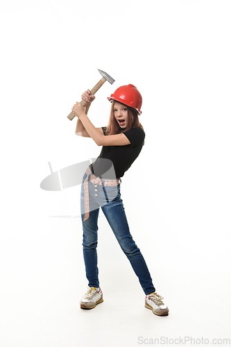 Image of A girl in a helmet hits herself on the head with a hammer