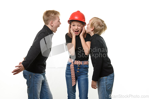 Image of Two boys are shouting at a girl, the girl is standing in a helmet in a hard hat and plugged her ears, isolated on a white background