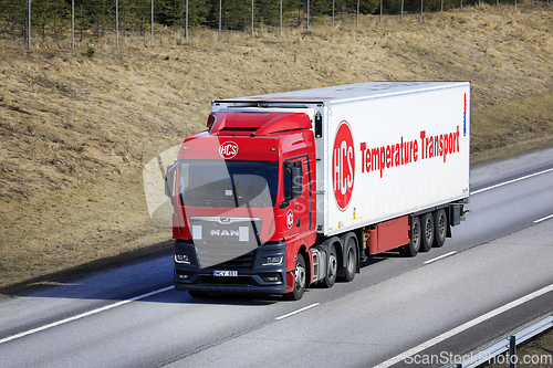 Image of Red MAN TGX 26.470 Truck Semi FRC Trailer on Road