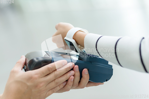 Image of Woman use of smart watch to pay