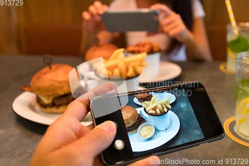 Image of Taking photo on cellphone in restaurant