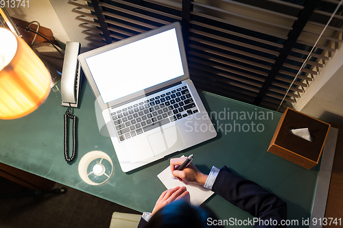 Image of Top view of businesswoman taking note on the desk