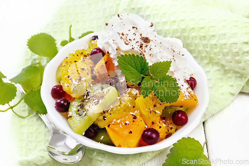 Image of Salad fruit with cranberries in bowl on light board