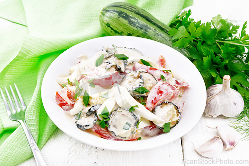 Image of Salad with fried zucchini in plate on light board