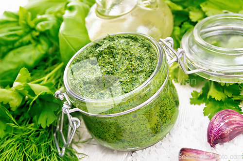 Image of Sauce of spicy greens in jar on light board