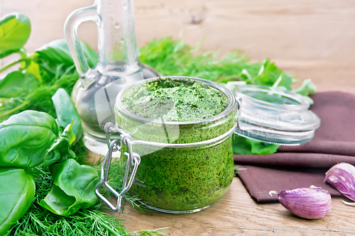 Image of Sauce of spicy greens in jar on old board