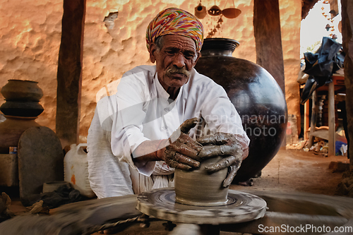 Image of Indian potter at work. Handwork craft from Shilpagram, Udaipur, Rajasthan, India