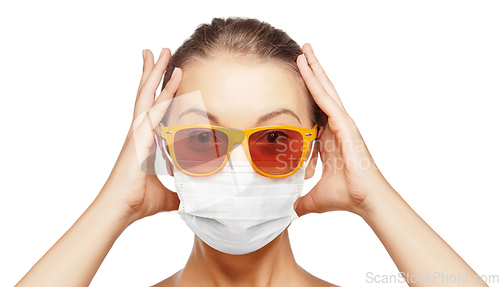 Image of surprised teenage girl in mask and sunglasses