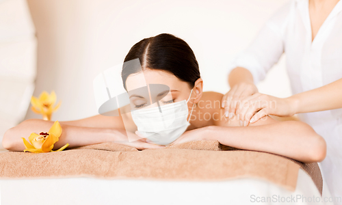 Image of woman lying and having back massage at spa