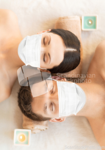 Image of couple in masks at aromatherapy at spa session