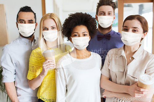 Image of business team in masks in office