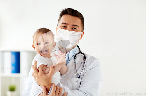 Image of doctor or pediatrician in mask with baby at clinic