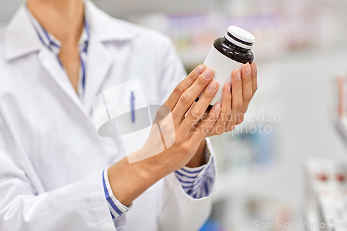 Image of close up of pharmacist with medicine at pharmacy