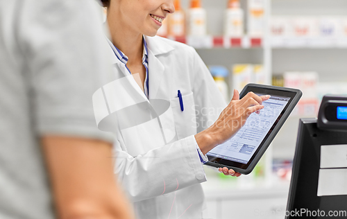 Image of female pharmacist with prescription on tablet pc