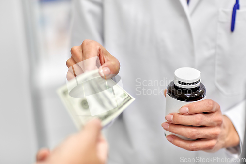 Image of close up of pharmacist selling drug at pharmacy