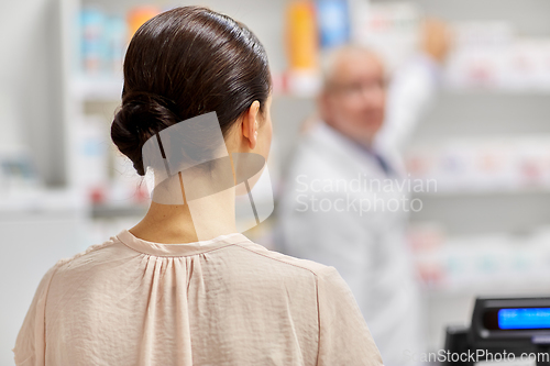 Image of woman buying medicine at pharmacy