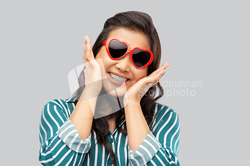 Image of happy asian woman with in heart shaped sunglasses