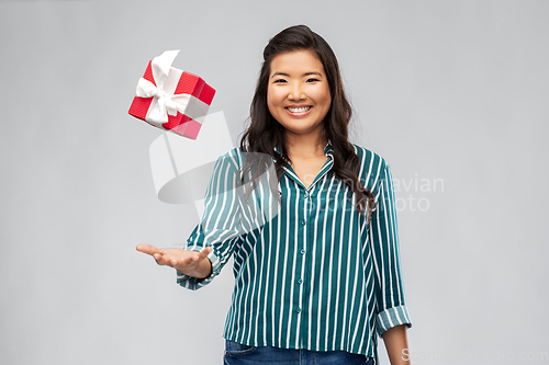 Image of happy asian woman with birthday present