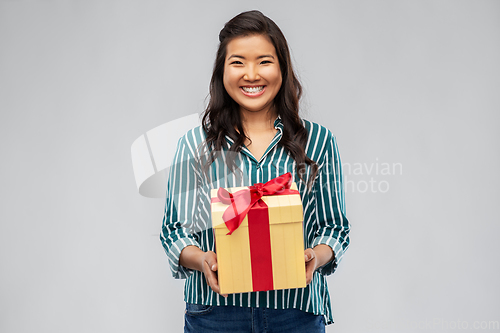 Image of happy asian woman with birthday present