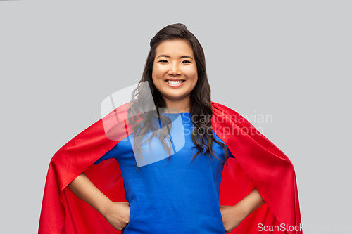 Image of happy asian woman in red superhero cape