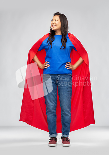 Image of happy asian woman in red superhero cape