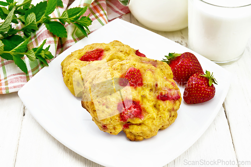 Image of Scones with strawberry in plate on wooden board