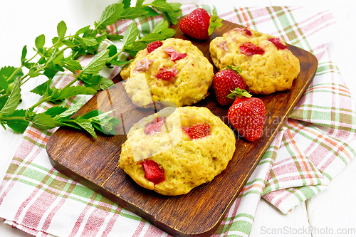 Image of Scones with strawberry on board