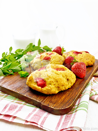 Image of Scones with strawberry on wooden board