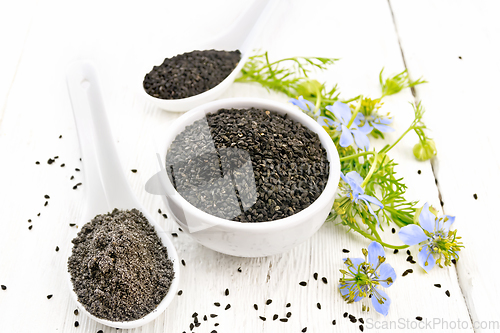 Image of Seeds of black cumin in bowl on light board