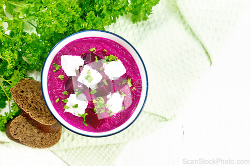 Image of Soup puree of beetroot with feta in bowl on board top