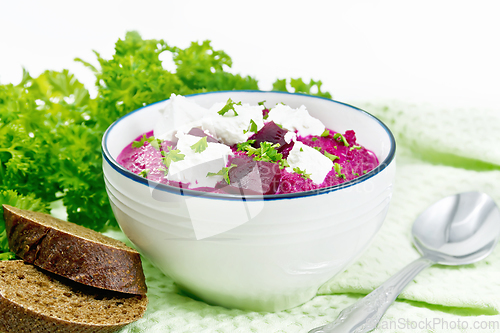 Image of Soup puree of beetroot with feta in bowl on light board