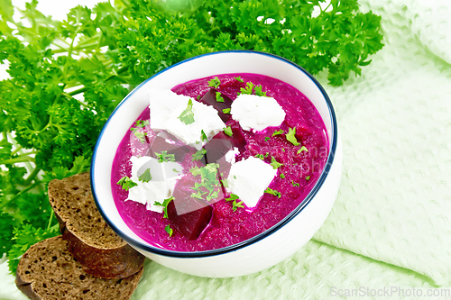 Image of Soup puree of beetroot with feta in bowl on wooden board