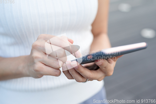 Image of Woman finger touch on mobile phone