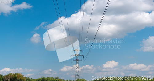 Image of cloudy morning sky and a high-voltage line
