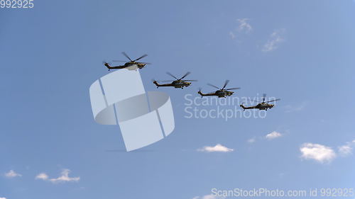 Image of Combat helicopters Mi-28 fly in blue sky