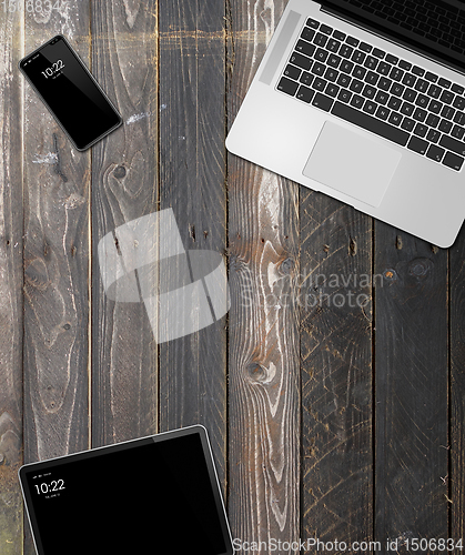 Image of Laptop, tablet and phone set mockup on a wooden background. 3D r