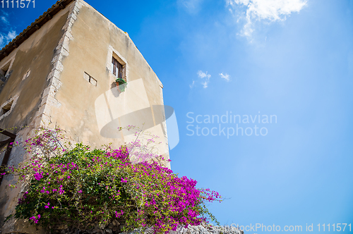Image of Sicily, Italy. Old house with purple flowers in Syracuse.
